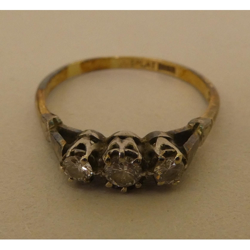 362 - A bi-coloured metal ring  stamped 'Plat', set with three white stones