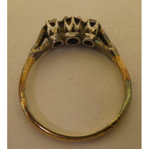 362 - A bi-coloured metal ring  stamped 'Plat', set with three white stones