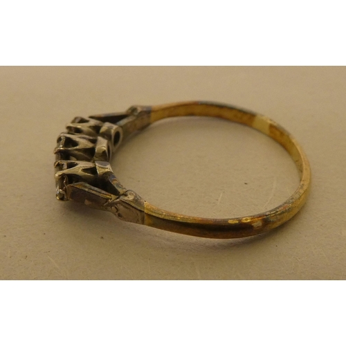 362 - A bi-coloured metal ring  stamped 'Plat', set with three white stones