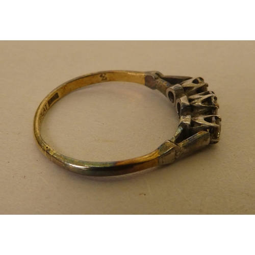 362 - A bi-coloured metal ring  stamped 'Plat', set with three white stones