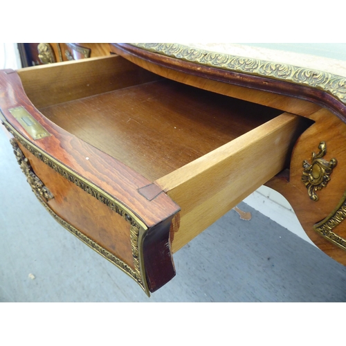 4 - A modern Louis XV design ormolu mounted desk, the serpentine front over three frieze drawers, raised... 