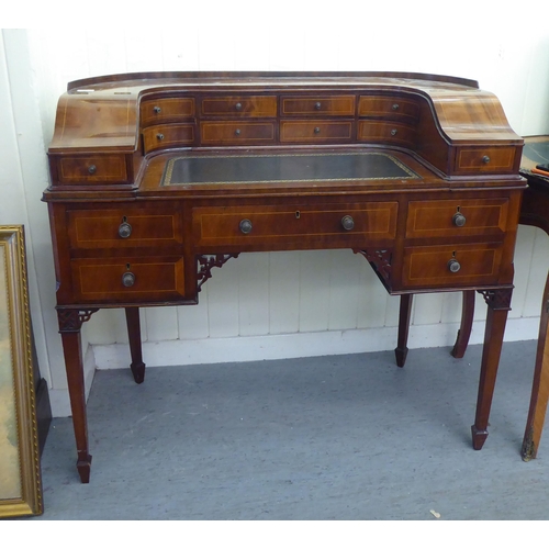 43 - A modern Carlton House design mahogany finished desk, raised on square, tapered legs  38