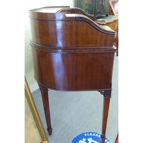 43 - A modern Carlton House design mahogany finished desk, raised on square, tapered legs  38