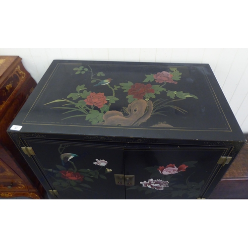 47 - A modern Chinese lacquered and overpainted, four door cabinet, raised on square legs  48