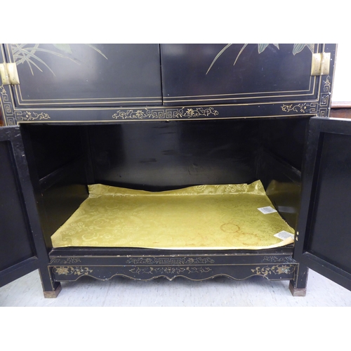 47 - A modern Chinese lacquered and overpainted, four door cabinet, raised on square legs  48