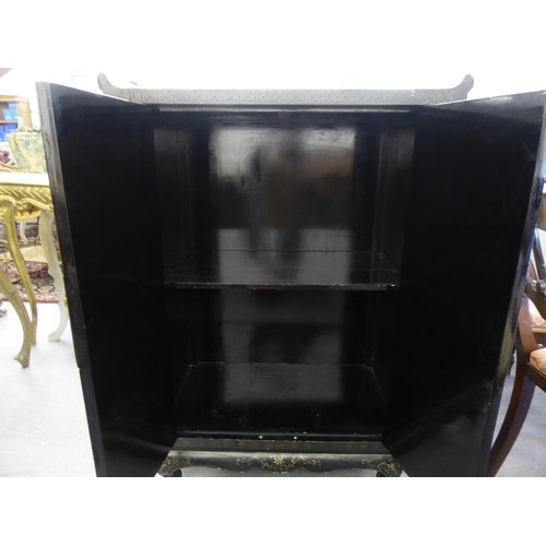 52 - A modern Chinese black lacquered, overpainted two door cabinet, on stubby cabriole feet  42.5