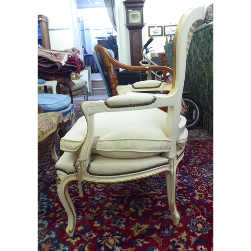 53 - A modern cream painted and upholstered bedroom chair with a caned back, raised on cabriole legs