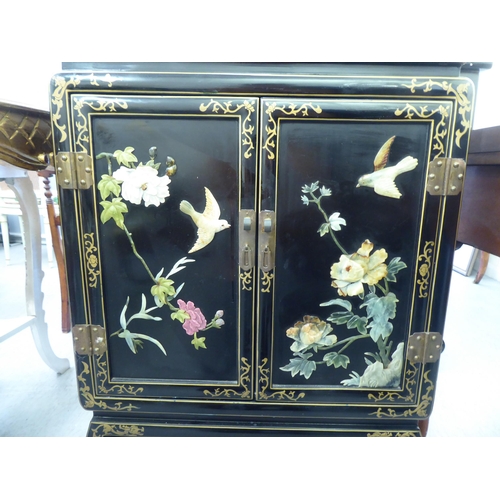 57 - A modern Chinese black lacquered, painted and hardstone inlaid Chinese cabinet, decorated with birds... 