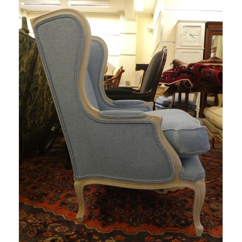 59 - A modern cream painted, blue upholstered arm chair, raised on cabriole legs