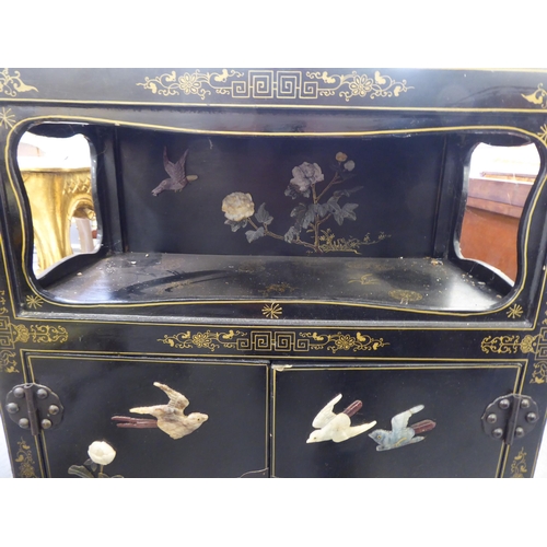 62 - A modern Chinese black lacquered, painted and hardstone inlaid cabinet  comprising an open shelf, ov... 