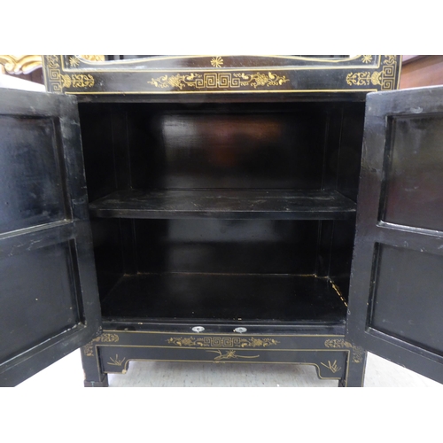 62 - A modern Chinese black lacquered, painted and hardstone inlaid cabinet  comprising an open shelf, ov... 