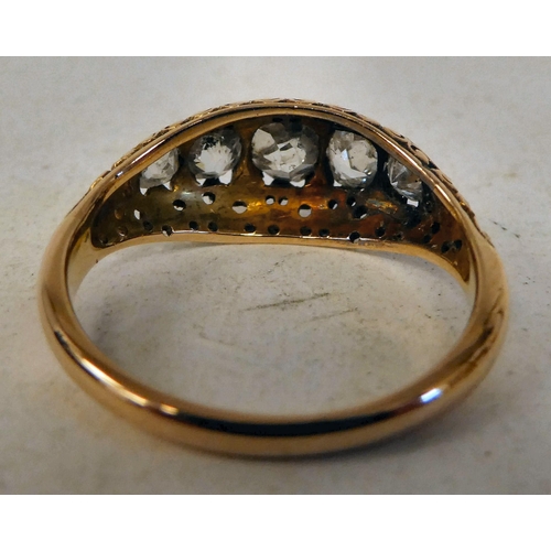 63 - A Victorian gold and black enamel, blue diamond ring, set with five graduated stones, on scrolled sh... 