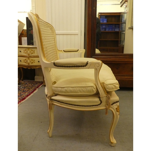 64 - A modern cream and gilt painted two person salon settee, raised on cabriole legs  49