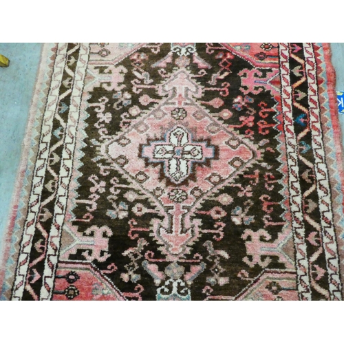 67 - A Persian rug with floral motifs, on a terracotta ground  35