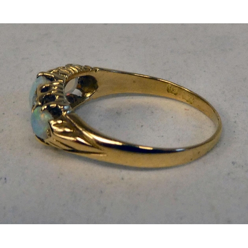 74 - An 18ct gold ring, set with three cabochon opals and four diamonds