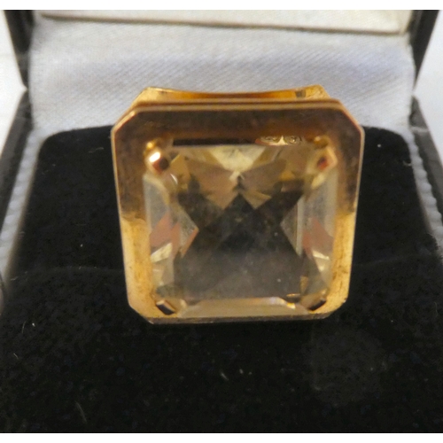 79 - A gold coloured metal ring, set with a citrine coloured stone  stamped 585  boxed