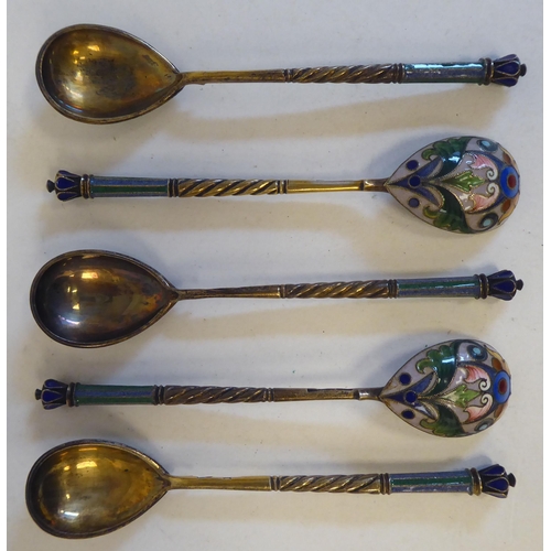 83 - A set of five Russian silver coffee spoons, the bowl backs and handle terminals with coloured enamel... 