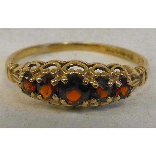 86 - A 9ct gold ring, set with a row of garnets