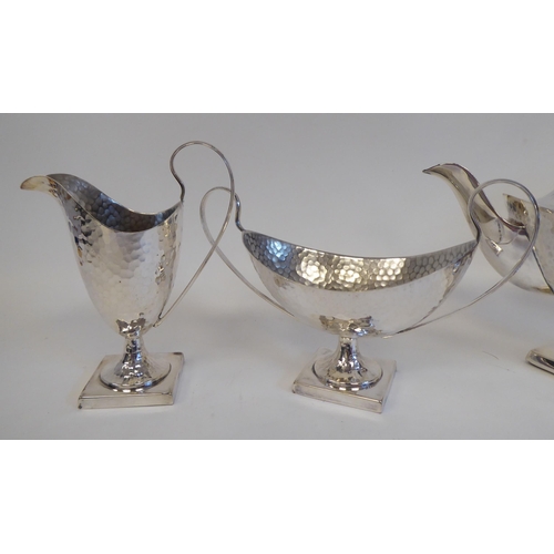 88 - A 20thC silver plated spot-hammered pedestal tea set