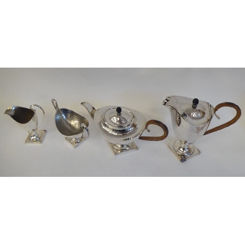 88 - A 20thC silver plated spot-hammered pedestal tea set