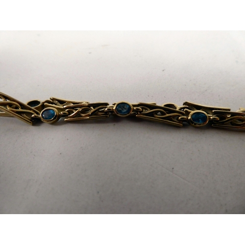 92 - A 9ct gold bracelet with eight rubover set blue topaz