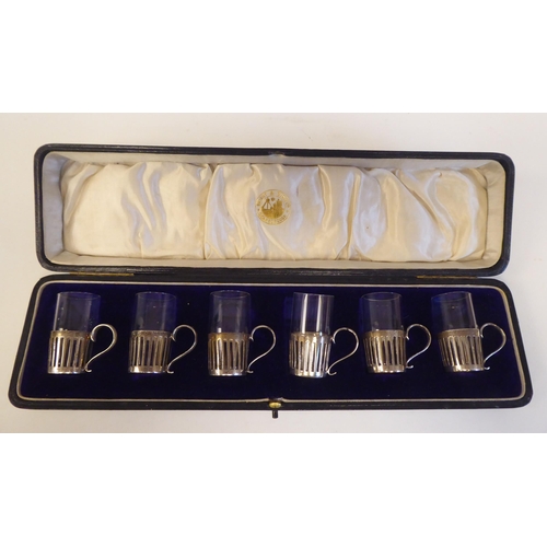 95 - A set of six George V silver framed tot mugs with clear liners  London 1914  cased