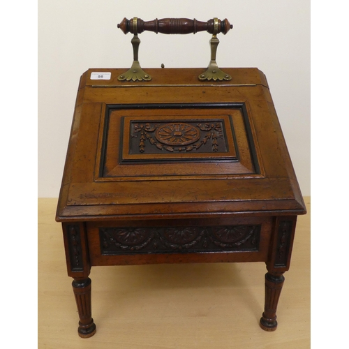 98 - An Edwardian mahogany purdonium of angular form with brass mounts and a carved, panelled, hinged lid... 