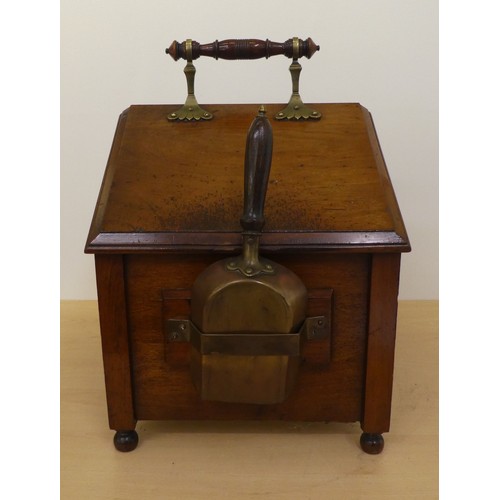 98 - An Edwardian mahogany purdonium of angular form with brass mounts and a carved, panelled, hinged lid... 