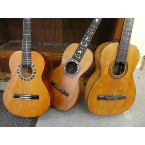 120 - Three similar guitars, in pine, fruitwood and mahogany