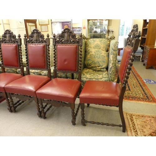 45 - A set of six 1920/30s baronial style oak framed dining chairs, each with an ornately carved crest, o... 