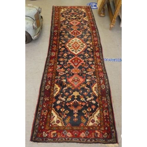 69 - A Persian runner with floral motifs, on a blue ground  35