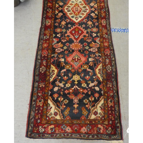 69 - A Persian runner with floral motifs, on a blue ground  35