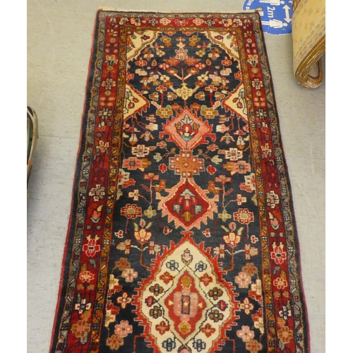 69 - A Persian runner with floral motifs, on a blue ground  35