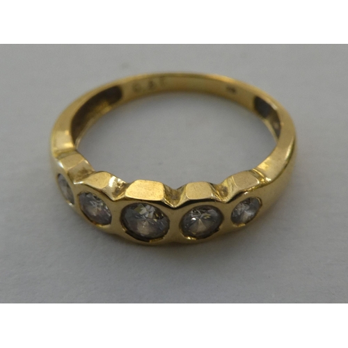 87 - An 18ct gold rubover ring, set with five diamonds