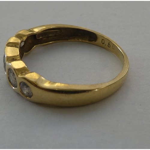 87 - An 18ct gold rubover ring, set with five diamonds