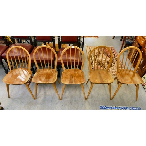 21 - A set of five Ercol (probably) beech and elm framed, hoop and spindled back chairs, the solid seats ... 