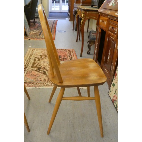 21 - A set of five Ercol (probably) beech and elm framed, hoop and spindled back chairs, the solid seats ... 