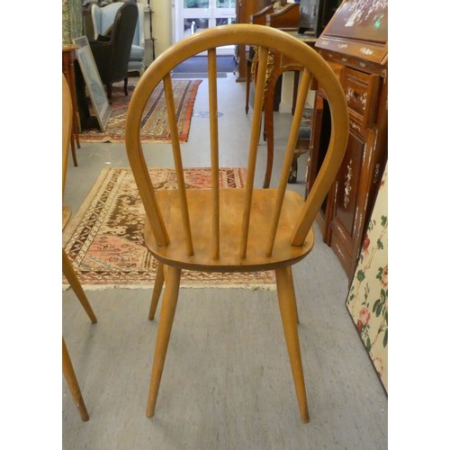 21 - A set of five Ercol (probably) beech and elm framed, hoop and spindled back chairs, the solid seats ... 