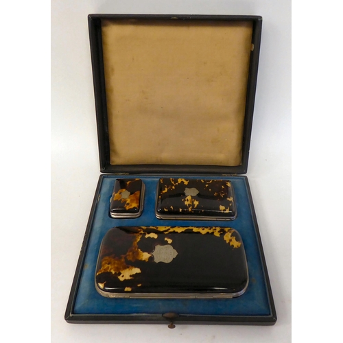 104 - A late Victorian graduated set of three, tortoiseshell and base metal bound purses  cased