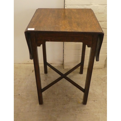 11 - A 1920s oak drop leaf occasional table, raised on square legs  28