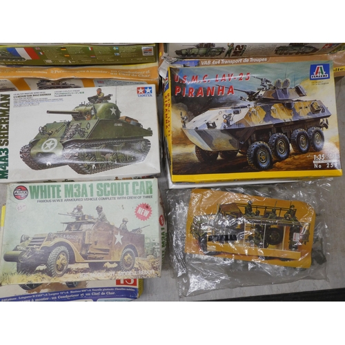 154 - 1/35 scale model kits: to include by Tamiya a 'M4A3 Sherman'; and a 'White M3A1 Scout Car' by Airfix... 