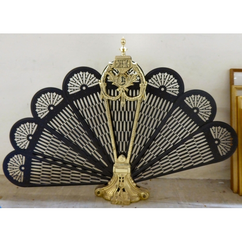 161 - A modern Victorian design gilt metal, fan design fireguard, raised on splayed feet  23