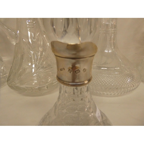 162 - Glassware: to include a lead crystal, thistle design decanter with a silver collar  marks indis... 