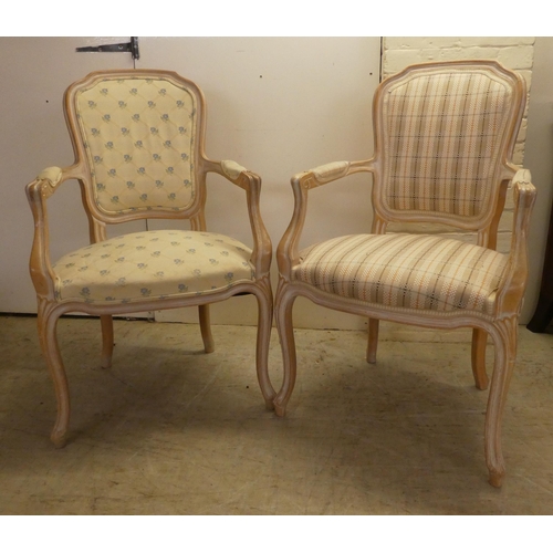 17 - A pair of modern antique French inspired cream wash painted, open arm salon chairs