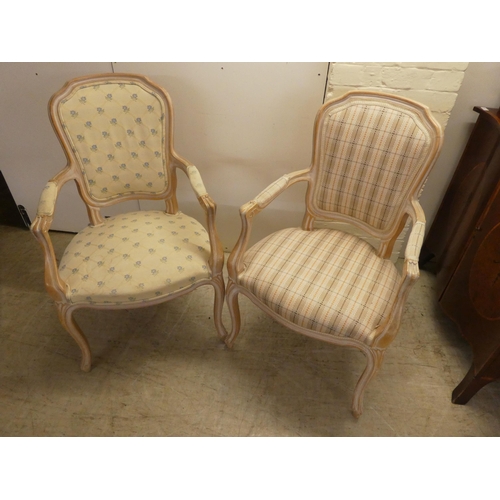 17 - A pair of modern antique French inspired cream wash painted, open arm salon chairs