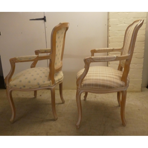 17 - A pair of modern antique French inspired cream wash painted, open arm salon chairs