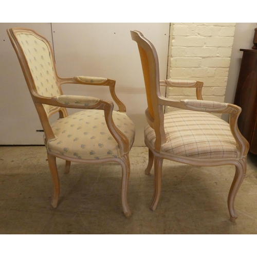 17 - A pair of modern antique French inspired cream wash painted, open arm salon chairs