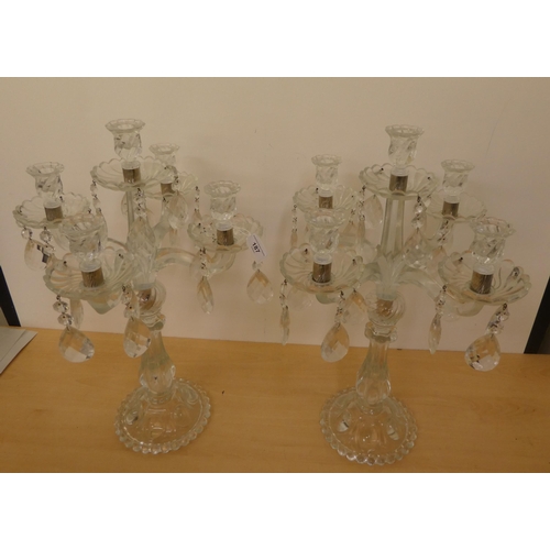 187 - A pair of 20thC moulded, clear glass, five branch candelabra with cut drops  24