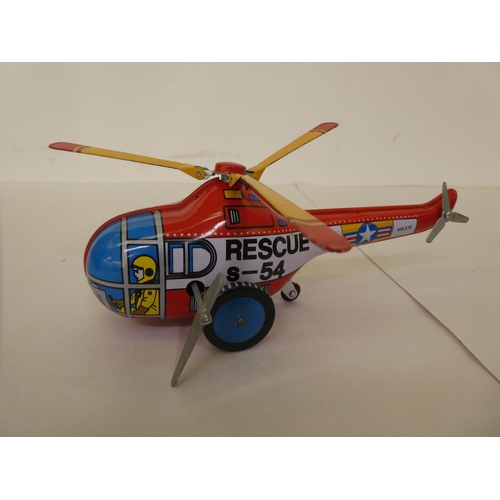 213 - Three Dinky diecast model aeroplanes and a car; and a Chinese made tinplate clockwork 'Rescue-Helico... 