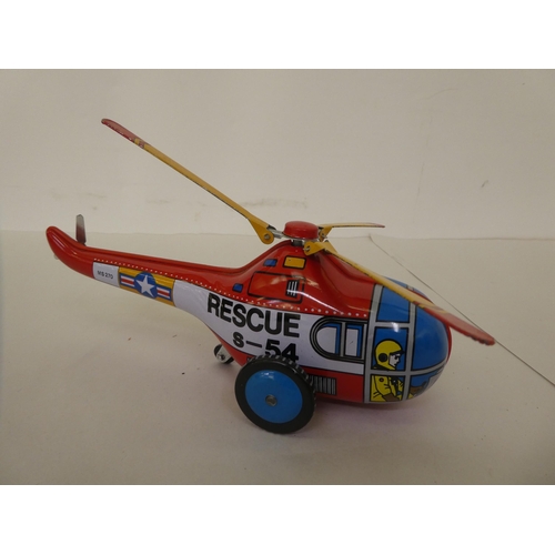 213 - Three Dinky diecast model aeroplanes and a car; and a Chinese made tinplate clockwork 'Rescue-Helico... 